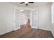 Bright office space with hardwood floors, white trim, large windows, and double French doors at 11896 Meade Ct, Westminster, CO 80031