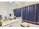 Bathroom with a shower-tub combo, white cabinets, and a large mirror, providing a functional space at 1192 S Zeno Way # E, Aurora, CO 80017