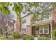 Charming townhouse with brick accents, lush landscaping, and inviting front porch bench at 1192 S Zeno Way # E, Aurora, CO 80017