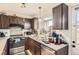 Functional kitchen with stainless steel appliances and ample counter space at 1192 S Zeno Way # E, Aurora, CO 80017