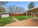 A well-maintained backyard featuring a wooden deck and a storage shed at 3342 S Flamingo Way, Denver, CO 80222