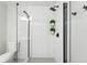 Updated bathroom features a modern glass shower with black trim, tiled walls, and a sleek, minimalist design at 3342 S Flamingo Way, Denver, CO 80222