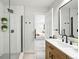 Chic bathroom features a sleek glass shower with modern black fixtures and an open doorway to the Primary bedroom at 3342 S Flamingo Way, Denver, CO 80222