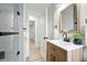 Modern bathroom featuring a glass enclosed shower and wood-grain vanity at 3342 S Flamingo Way, Denver, CO 80222