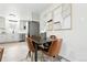 Dining area features modern art, a table with leather chairs, and kitchen access at 3342 S Flamingo Way, Denver, CO 80222