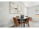 Dining area features modern art, a table with leather chairs, with natural light from windows at 3342 S Flamingo Way, Denver, CO 80222
