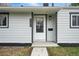 Close-up of the front door with the house number and modern exterior lighting at 3342 S Flamingo Way, Denver, CO 80222