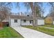 View of the home's exterior showcasing the siding and driveway in a landscaped yard at 3342 S Flamingo Way, Denver, CO 80222
