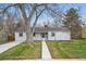 Charming single-story home with a well-maintained lawn and mature trees at 3342 S Flamingo Way, Denver, CO 80222