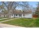 Cozy home on a grassy lot with mature trees and landscaping at 3342 S Flamingo Way, Denver, CO 80222