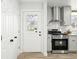 Renovated kitchen features stainless steel appliances and bright white trim, with an access door at 3342 S Flamingo Way, Denver, CO 80222
