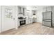 Updated kitchen showcases stainless appliances, gray cabinets, and an exterior door for convenience at 3342 S Flamingo Way, Denver, CO 80222