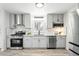 Bright kitchen features stainless appliances, light gray cabinets, and classic subway tile backsplash at 3342 S Flamingo Way, Denver, CO 80222