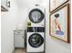 Modern laundry room with stacked washer and dryer next to decor at 3342 S Flamingo Way, Denver, CO 80222