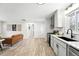 Open-concept space includes a seating area with updated kitchen featuring stainless appliances at 3342 S Flamingo Way, Denver, CO 80222