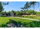 A scenic park with open green spaces, trees, and a paved path at 3342 S Flamingo Way, Denver, CO 80222