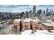 Aerial view of the building, cityscape backdrop, mountains in distance at 1630 N Clarkson St # 320, Denver, CO 80218