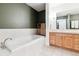 Clean bathroom with a large soaking tub and double vanity at 1630 N Clarkson St # 320, Denver, CO 80218