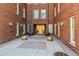 Courtyard entrance with brick building and potted plants at 1630 N Clarkson St # 320, Denver, CO 80218