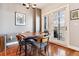 Small dining area with wooden table and chairs, access to balcony at 1630 N Clarkson St # 320, Denver, CO 80218