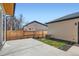 Fenced backyard with a concrete patio and a patch of grass, perfect for outdoor relaxation and entertainment at 4211 Vallejo St, Denver, CO 80211