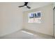 Minimalist bedroom with carpet, neutral walls, modern ceiling fan and large window at 4211 Vallejo St, Denver, CO 80211