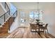 Bright dining room with modern chandelier, staircase, and large windows overlooking the outdoors at 4211 Vallejo St, Denver, CO 80211