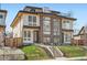 Modern duplex featuring a rooftop deck, large windows, and a well-manicured front yard at 4211 Vallejo St, Denver, CO 80211