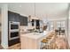 Modern kitchen with sleek black cabinets, spacious island, and stainless steel appliances at 4211 Vallejo St, Denver, CO 80211