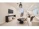 Contemporary living room with cozy seating, a sleek entertainment console, and stylish decorative accents at 4211 Vallejo St, Denver, CO 80211