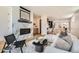 Bright living room featuring a modern fireplace, stylish decor, and an open floor plan at 4211 Vallejo St, Denver, CO 80211