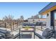 Stylish rooftop deck featuring comfortable seating and views of the surrounding neighborhood and city skyline at 4211 Vallejo St, Denver, CO 80211