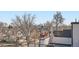 View from a rooftop terrace showcasing the surrounding neighborhood and the city skyline in the distance at 4211 Vallejo St, Denver, CO 80211