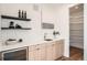 Modern wet bar with sleek countertops, open shelving, and a stylish under-counter beverage cooler at 4211 Vallejo St, Denver, CO 80211