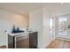 Wet bar featuring a modern sink, sleek cabinetry, and a built-in beverage refrigerator at 4211 Vallejo St, Denver, CO 80211