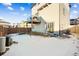 Rear view of the home with backyard showing the patio deck and the light colored siding at 20054 E 48Th Dr, Denver, CO 80249