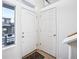 Bright entryway features a coat closet and a window overlooking a snow-covered yard with nearby buildings at 20054 E 48Th Dr, Denver, CO 80249