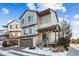 Contemporary two-story townhome with a front-facing two-car garage, landscaped front yard, and covered entryway at 20054 E 48Th Dr, Denver, CO 80249