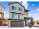 Charming two-story townhome with a front-facing garage, landscaped front yard, and covered entryway at 20054 E 48Th Dr, Denver, CO 80249