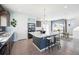 Bright kitchen featuring a large island with stools, modern appliances, and tile flooring throughout at 20054 E 48Th Dr, Denver, CO 80249