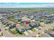 Expansive neighborhood with well-maintained homes, green spaces, and tree-lined streets under a blue sky at 3086 Kestrel St, Brighton, CO 80601