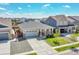 Aerial view of a well-maintained home with a two-car garage, landscaping, and neighborhood at 3086 Kestrel St, Brighton, CO 80601