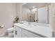 Bright bathroom featuring white vanity, toilet, and large mirror over the sink at 3086 Kestrel St, Brighton, CO 80601