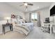 Comfortable bedroom with neutral tones, large window, and plush bedding, also has a desk for office use at 3086 Kestrel St, Brighton, CO 80601