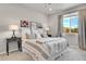 Comfortable bedroom with neutral tones, large window, and plush bedding for a serene and inviting atmosphere at 3086 Kestrel St, Brighton, CO 80601