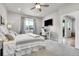 Comfortable bedroom with neutral tones, large window, plush bedding, a desk, and an ensuite for added privacy at 3086 Kestrel St, Brighton, CO 80601