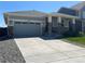 Beautifully landscaped single-story home with a spacious driveway and stone accents on the facade at 3086 Kestrel St, Brighton, CO 80601