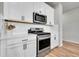 Close up of a kitchen featuring white cabinetry, stainless steel gas range and quartz countertops at 3086 Kestrel St, Brighton, CO 80601