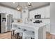 Modern kitchen with white cabinetry, stainless steel appliances, and quartz countertops at 3086 Kestrel St, Brighton, CO 80601