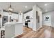 Bright, open kitchen featuring stainless steel appliances and an island with barstool seating at 3086 Kestrel St, Brighton, CO 80601